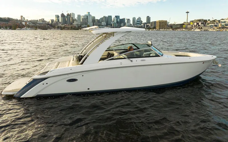 Slide: The Image of 2018 Cobalt 30 R boat cruising on a city waterfront. - 14