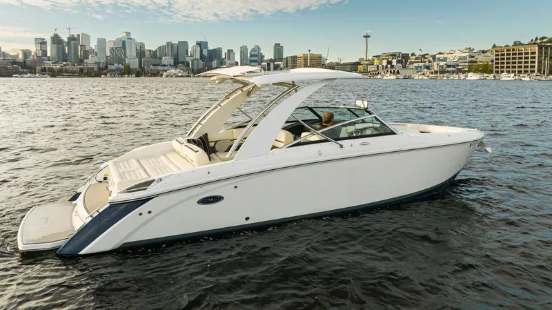 Slide: The Image of 2018 Cobalt 30 R boat cruising near city skyline. - 16