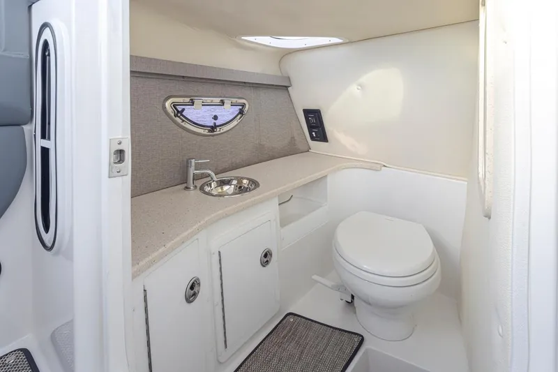 Slide: The Image of 2018 Cobalt 30 R boat bathroom with sink, toilet, and storage cabinets. - 20