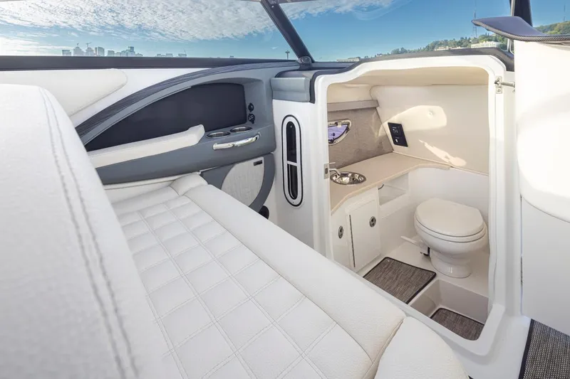 Slide: The Image of 2018 Cobalt 30 R boat interior with luxurious seating and compact bathroom. - 21