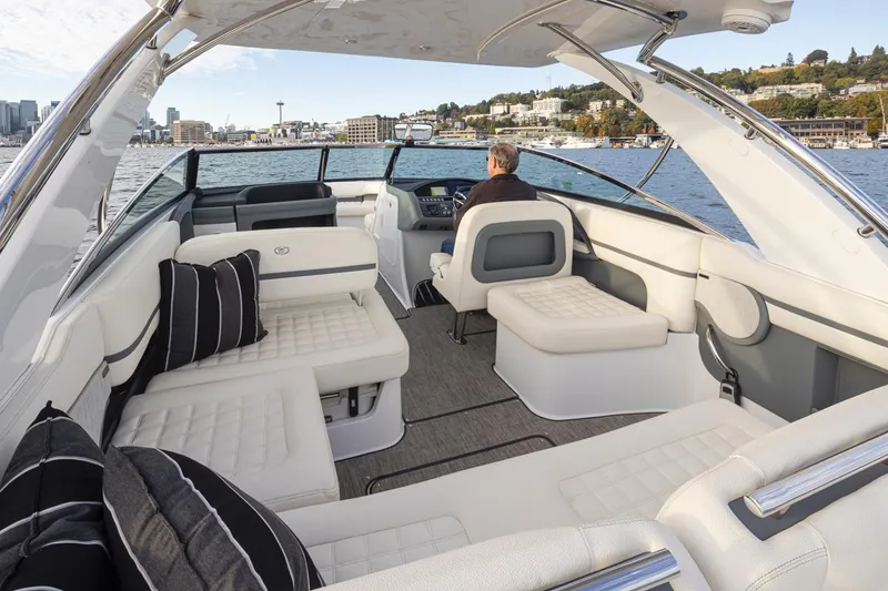 Slide: The Image of 2018 Cobalt 30 R luxury boat interior with white seating and scenic water view. - 22