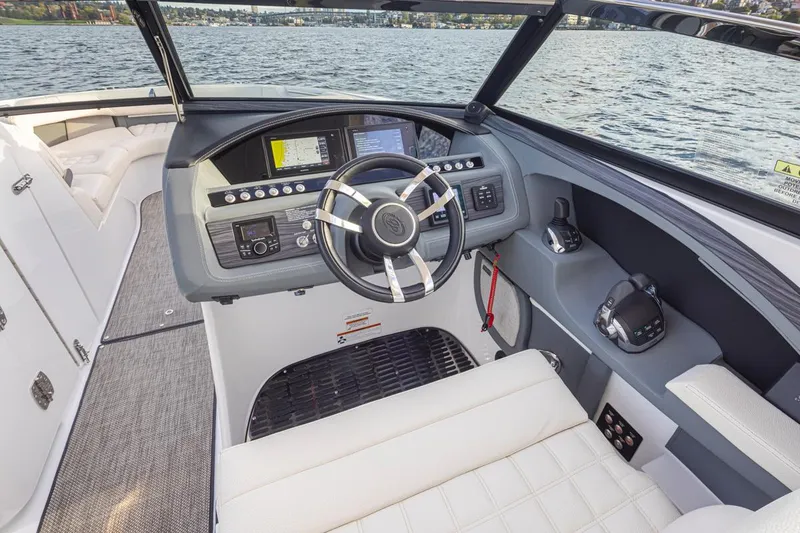 Slide: The Image of 2018 Cobalt 30 R boat cockpit with steering wheel and control panel. - 25