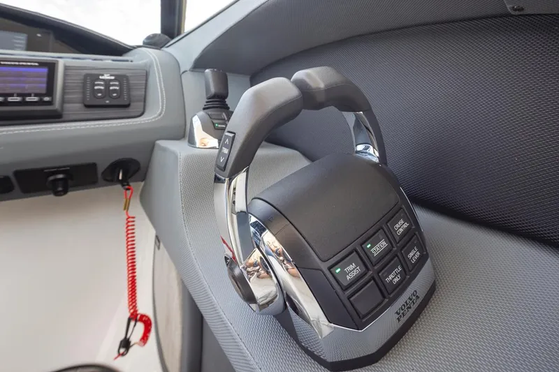 Slide: The Image of Close-up of 2018 Cobalt 30 R boat throttle controls and dashboard. - 26
