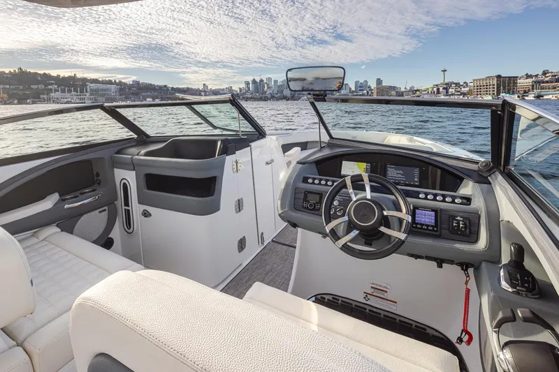 Slide: The Image of 2018 Cobalt 30 R boat interior with city skyline in the background. - 28