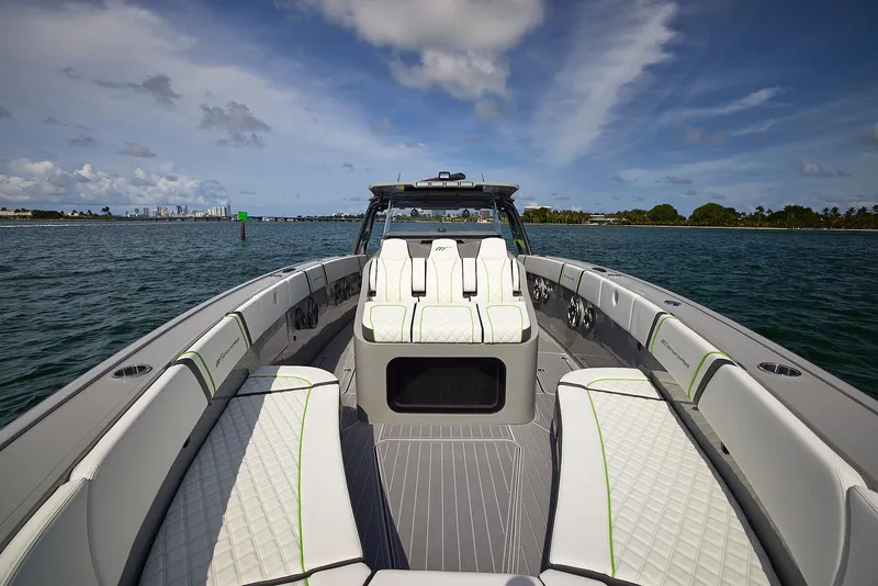 Slide: The Image of 2022 Midnight Express 43' Solstice boat with luxurious seating on open water. - 11