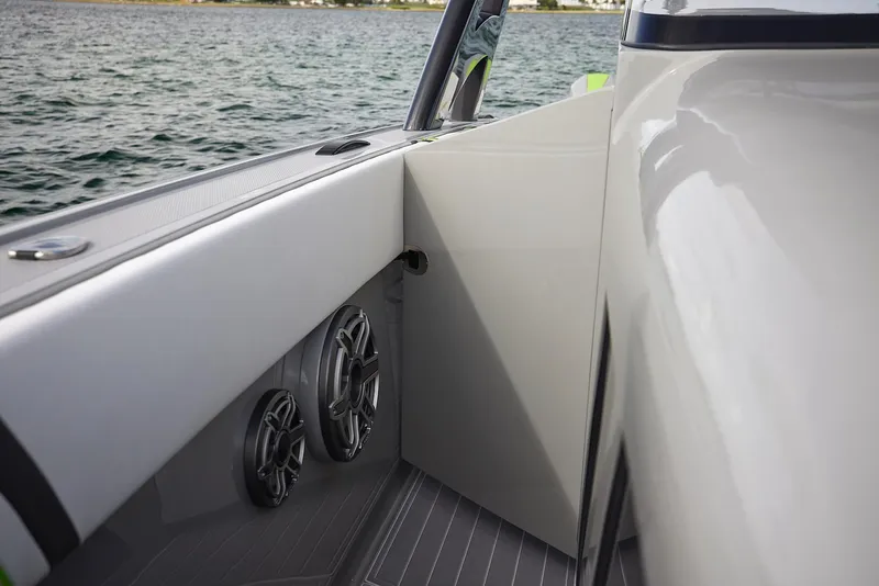 Slide: The Image of 2022 Midnight Express 43' Solstice boat interior with speakers, on calm water. - 15