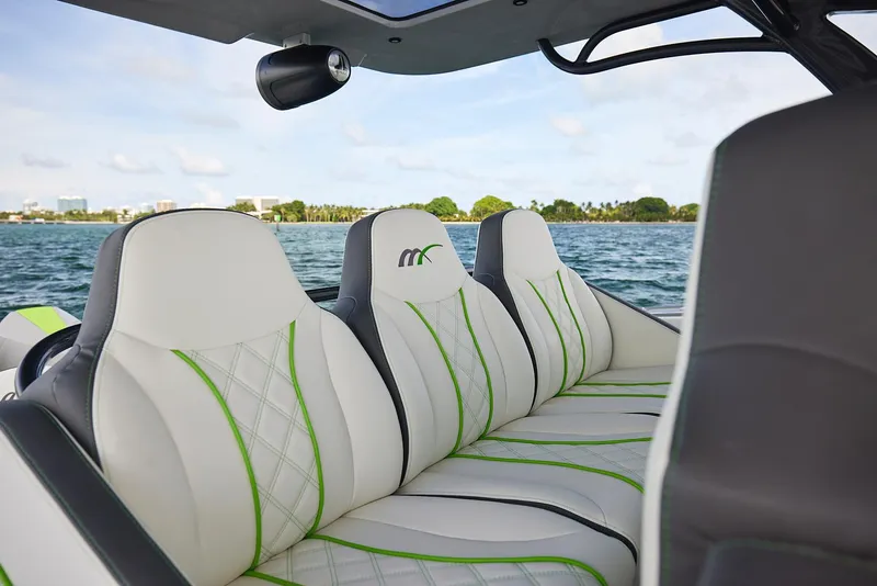 Slide: The Image of Luxury seating on 2022 Midnight Express 43' Solstice boat, featuring white and green upholstery. - 18