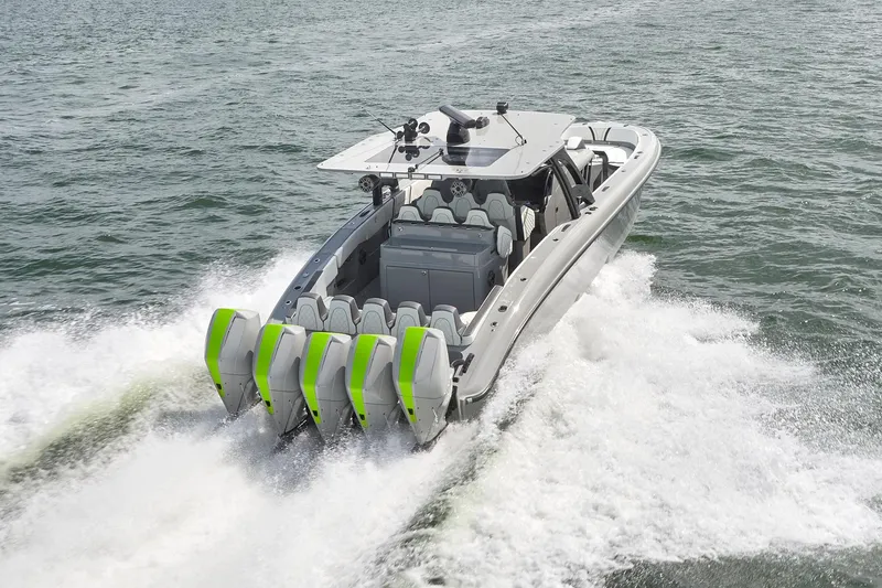 Slide: The Image of 2022 Midnight Express 43' Solstice boat with five outboard engines cruising on water. - 2