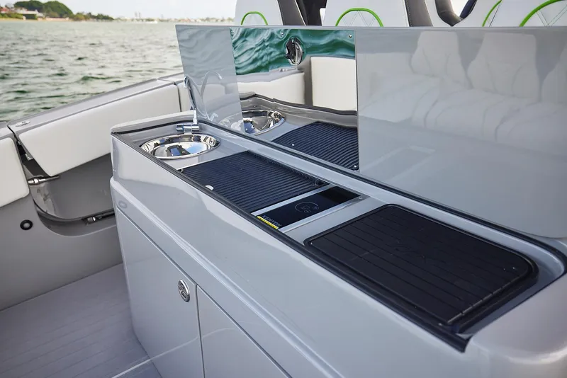 Slide: The Image of Luxury outdoor kitchen on 2022 Midnight Express 43' Solstice boat, featuring sleek countertops and appliances. - 20