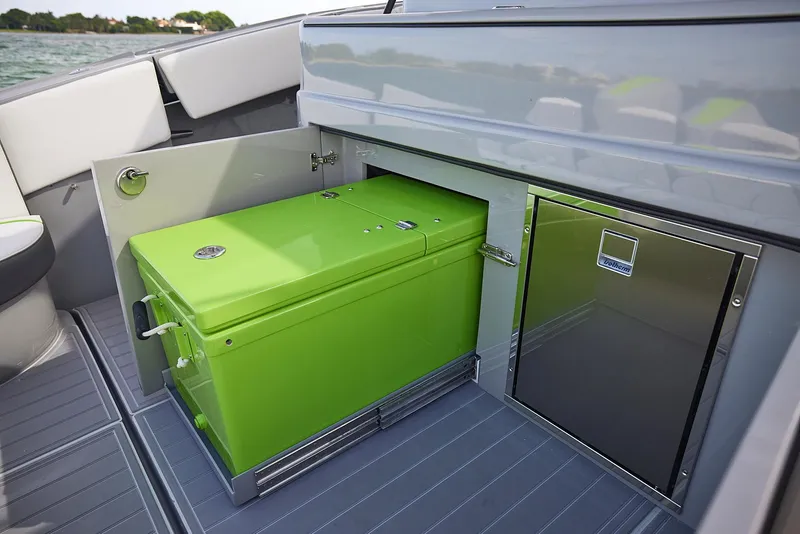Slide: The Image of 2022 Midnight Express 43' Solstice boat with green storage compartment and stainless steel cabinet. - 21