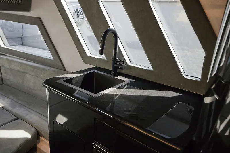 Slide: The Image of Interior of 2022 Midnight Express 43' Solstice yacht with sleek black sink and modern design. - 26
