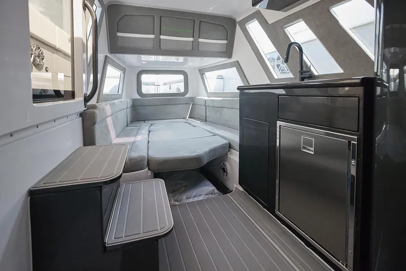 Slide: The Image of Interior of 2022 Midnight Express 43' Solstice boat with modern seating and kitchenette. - 27