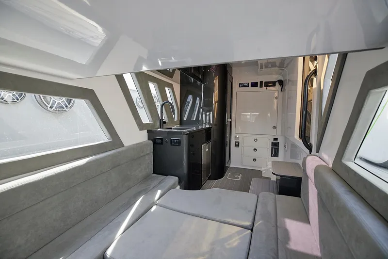 Slide: The Image of Interior of 2022 Midnight Express 43' Solstice yacht, featuring modern seating and kitchenette. - 28