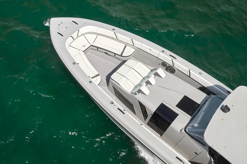 Slide: The Image of 2022 Midnight Express 43' Solstice boat cruising on clear green water. - 5