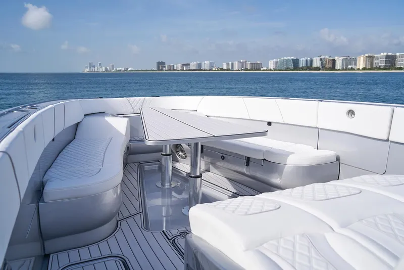 Slide: The Image of 2021 Midnight Express 43' Open luxury boat with white seating and ocean view. - 12