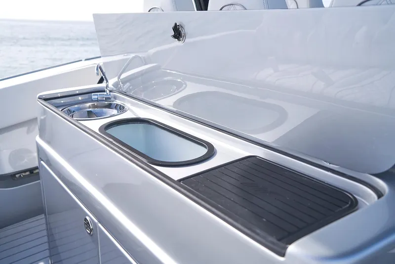 Slide: The Image of 2021 Midnight Express 43' Open yacht kitchen area with sink and cutting board. - 17