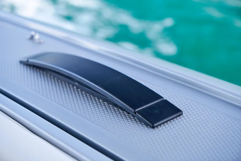 Slide: The Image of Close-up of a 2021 Midnight Express 43' Open boat handle against turquoise water. - 20