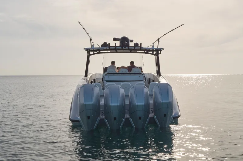 Slide: The Image of 2021 Midnight Express 43' Open boat with four outboard engines on calm water. - 6