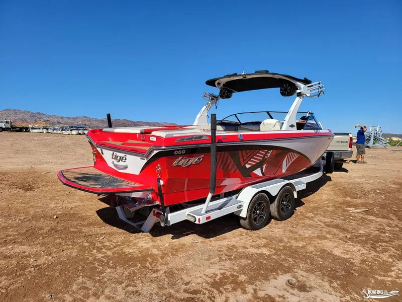 Slide: The Image of 2016 Tigé Z3 boat on trailer, vibrant red design, parked on dry land. - 14