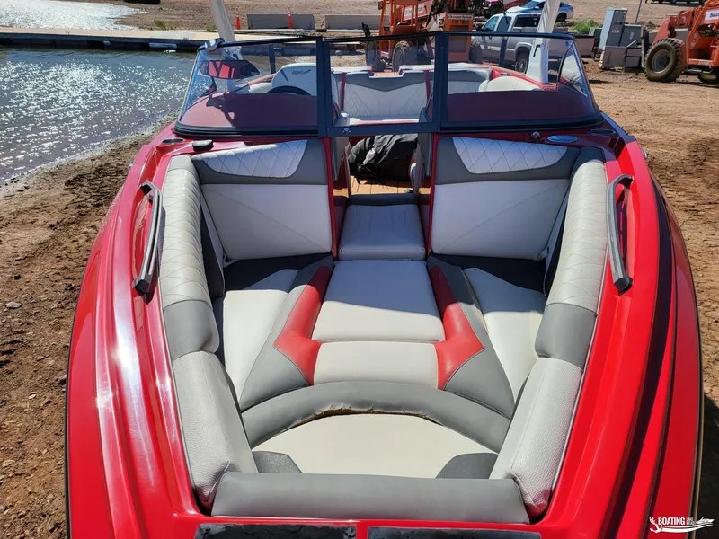 Slide: The Image of 2016 Tigé Z3 boat with red and gray interior, docked by the water. - 15