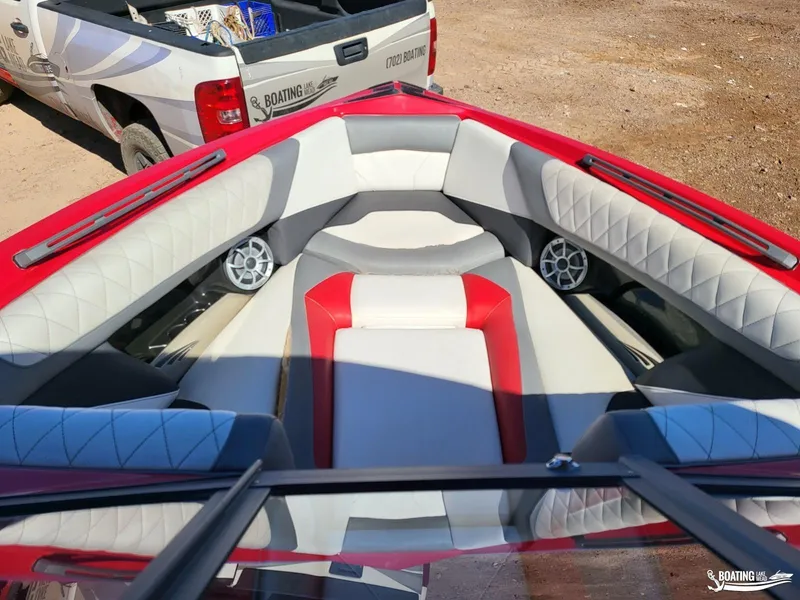 Slide: The Image of 2016 Tigé Z3 boat interior with red and white seating, parked near a pickup truck. - 19