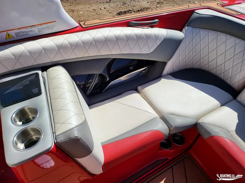 Slide: The Image of 2016 Tigé Z3 boat interior with red and white seating, cup holders, and diamond stitching. - 20