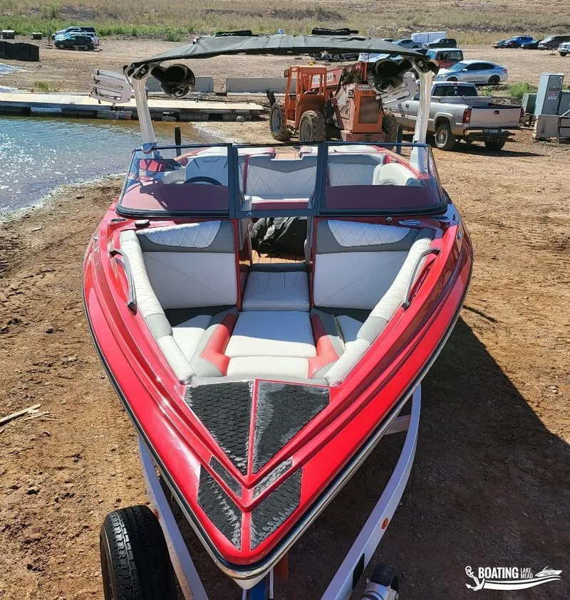 Slide: The Image of 2016 Tigé Z3 boat with red and white interior, parked near a lake. - 7