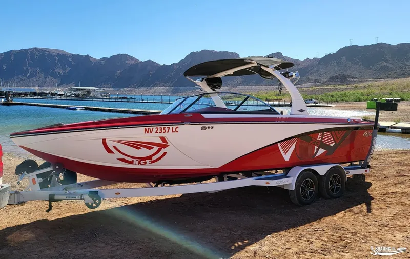 Slide: The Image of 2016 Tigé Z3 boat on trailer by lake, mountainous backdrop. - 8