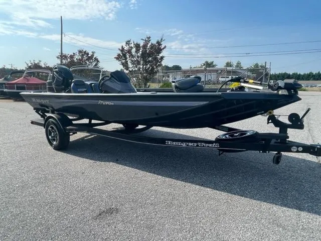 The Image of 2024 Ranger RT178C fishing boat on a trailer in a parking lot. - 0