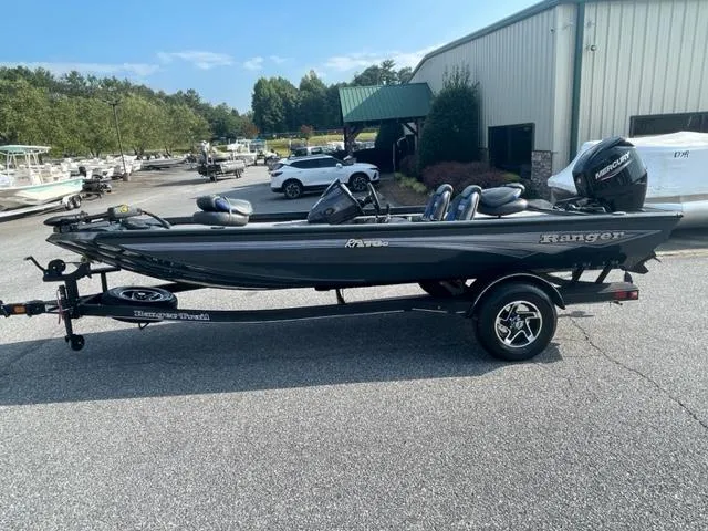 Slide: The Image of 2024 Ranger RT178C fishing boat on trailer, parked outside dealership. - 1