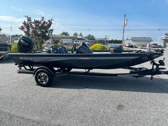 Slide: The Image of 2024 Ranger RT178C fishing boat on trailer, side view, outdoors. - 2
