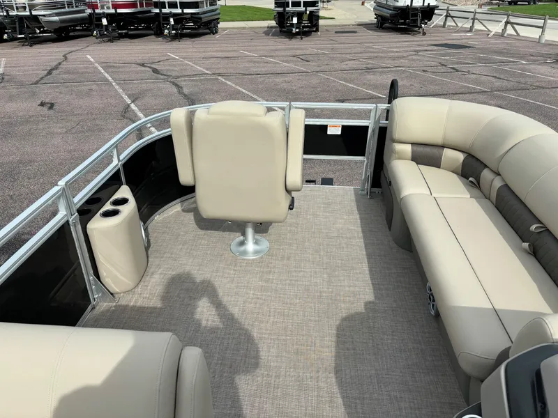 Slide: The Image of 2024 Sun Tracker SportFish 20 DLX pontoon boat interior with beige seating. - 6