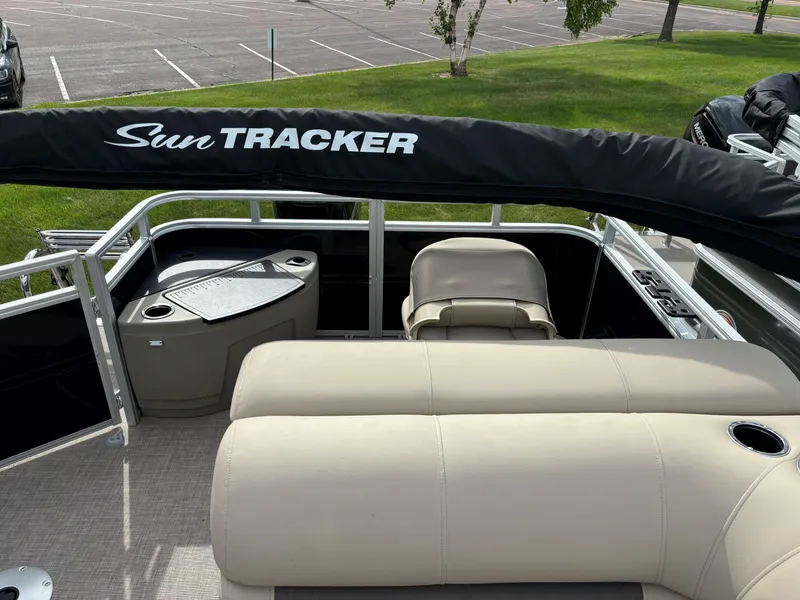 Slide: The Image of 2024 Sun Tracker SportFish 20 DLX pontoon boat interior with seating and storage. - 9