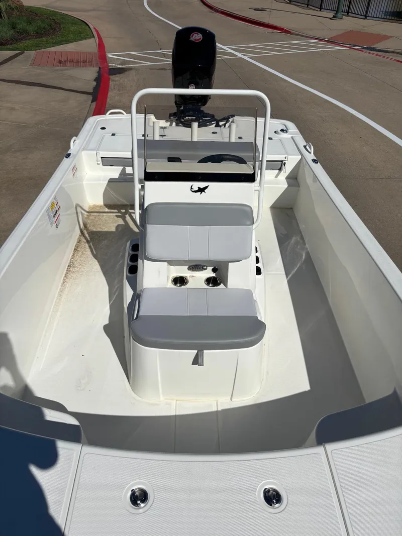 Slide: The Image of 2024 Mako Pro Skiff 19 CC boat interior with seating and console. - 4