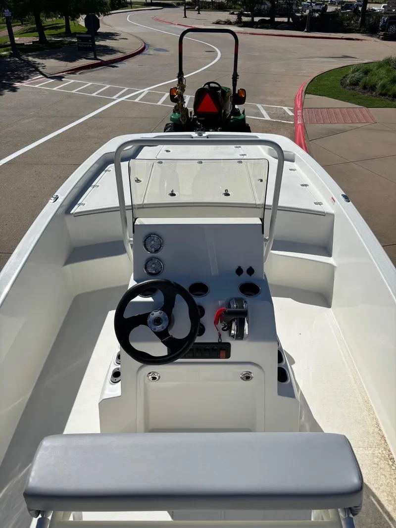 Slide: The Image of 2024 Mako Pro Skiff 19 CC boat interior with steering console and seating. - 5