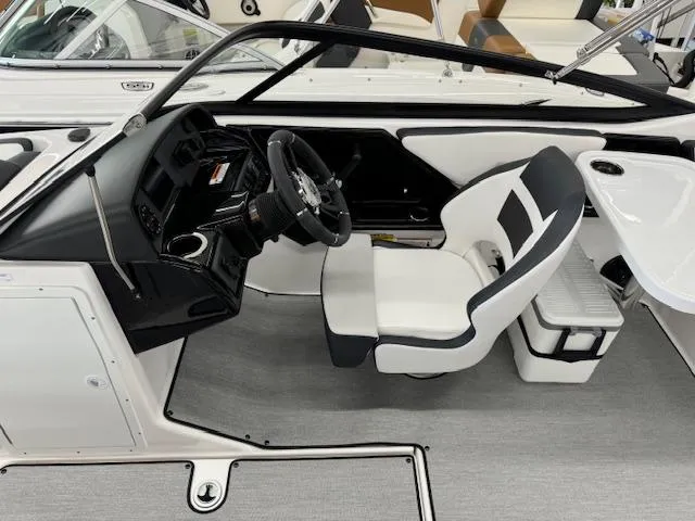 Slide: The Image of 2024 Yamaha Boats SX195 interior cockpit with steering wheel and captain's chair. - 10