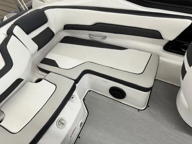 Slide: The Image of 2024 Yamaha Boats SX195 interior seating with white and black upholstery. - 14
