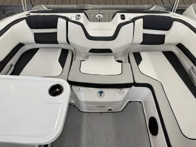 Slide: The Image of 2024 Yamaha Boats SX195 interior seating area with white and black upholstery. - 15