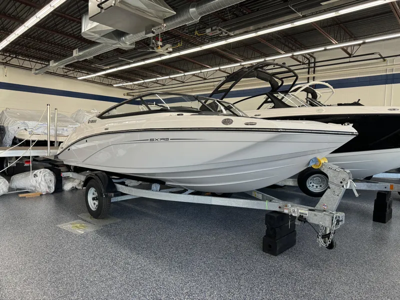 Slide: The Image of 2024 Yamaha Boats SX195 on trailer in showroom. - 2