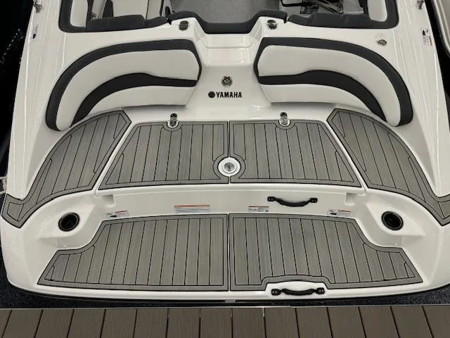 Slide: The Image of 2024 Yamaha Boats SX195 swim platform with cushioned seating and non-slip decking. - 20