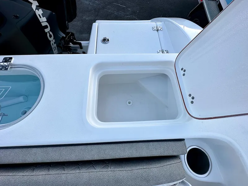 Slide: The Image of 2024 Sea Pro 222 boat with open storage compartment and Mercury engine. - 11