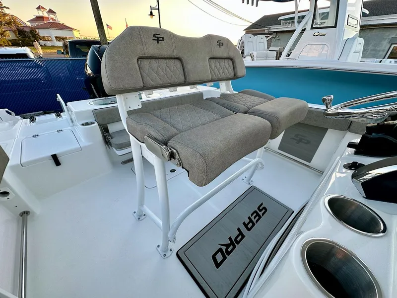 Slide: The Image of 2024 Sea Pro 222 boat interior with cushioned seating and steering console. - 6