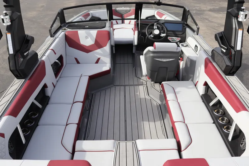 Slide: The Image of 2024 Nautique GS22 boat interior with red and white seating, spacious layout, and modern design. - 10