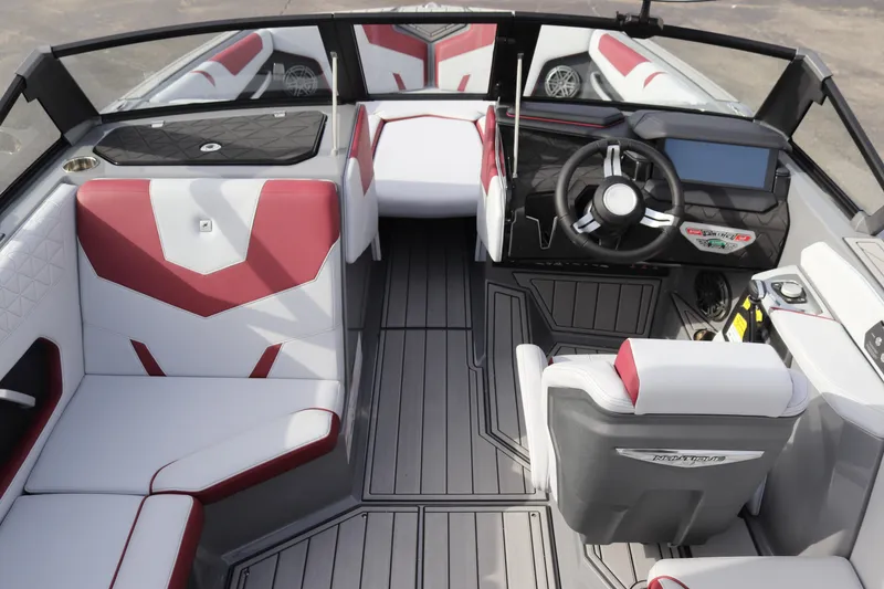 Slide: The Image of 2024 Nautique GS22 boat interior with red and white seating and modern dashboard. - 11