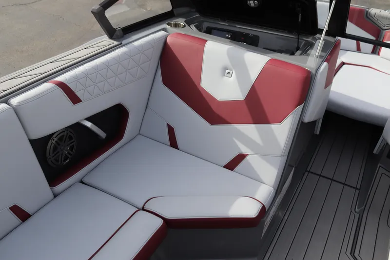 Slide: The Image of 2024 Nautique GS22 boat interior with red and white upholstery. - 14