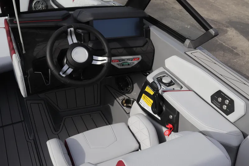 Slide: The Image of 2024 Nautique GS22 boat cockpit with modern steering wheel and control panel. - 15