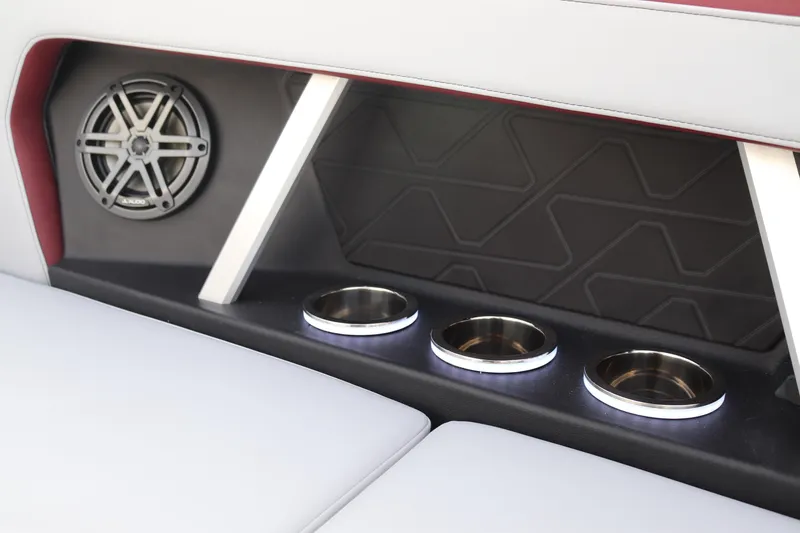Slide: The Image of 2024 Nautique GS22 interior with illuminated cup holders and speaker. - 16
