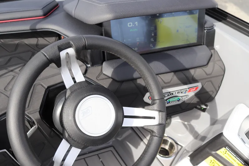 Slide: The Image of 2024 Nautique GS22 boat dashboard with steering wheel and touchscreen display. - 18