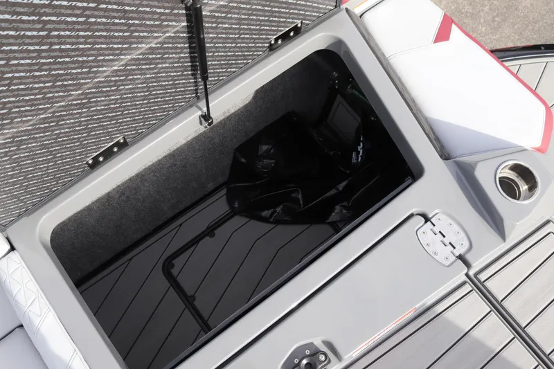 Slide: The Image of 2024 Nautique GS22 storage compartment with open lid. - 21