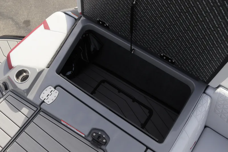 Slide: The Image of 2024 Nautique GS22 boat storage compartment with open hatch. - 22